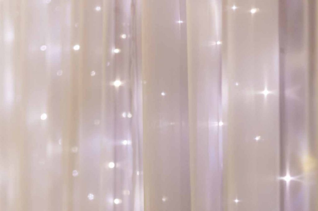 Fairy lights adorned in a white curtain